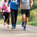 midsection-of-large-group-of-people-running-a-race-competition-in-nature.jpg